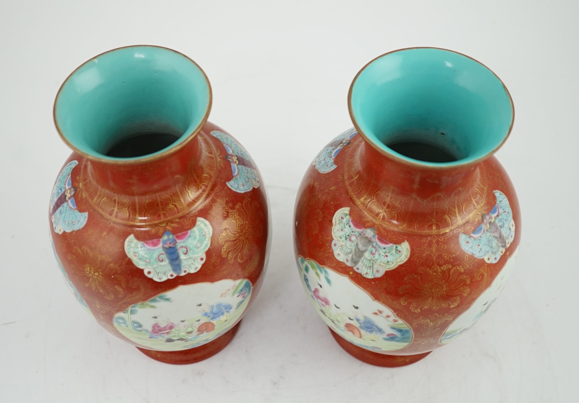 A pair of Chinese coral ground ‘boys’ vases, Jiaqing period (1796-1820)